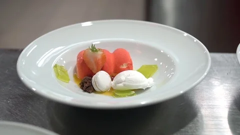 Cook serving a dessert on a white plate. 動画素材 100675334