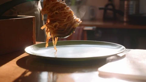 Cook serving spaghetti on the plate Stock Footage 100590221
