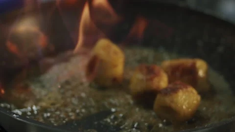 The cook sets fire to alcohol in a hot frying pan with banana and butter Stock-Footage 154147262