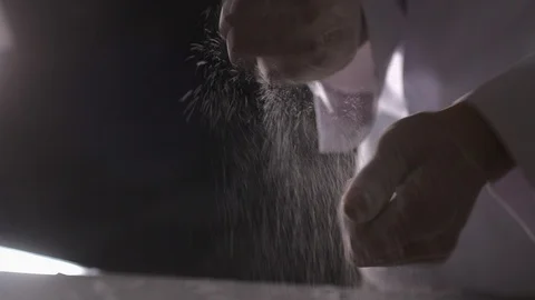 Cook shakes off hands with flour Stock Footage 87635808