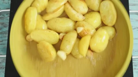 The cook shakes the pan while the potatoes are frying. Stock Footage 207023873