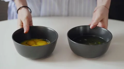 The cook shows the camera plates with egg yolk and white. 動画素材 149558757