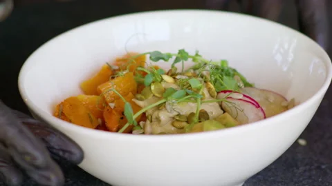 Cook shows the salad to the client. Hands rotate a plate of vegetarian salad. Video stock 158774789