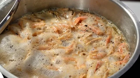 Cook shrimp shells to prepare a broth, adding the water for cooking Stock Footage 219716978