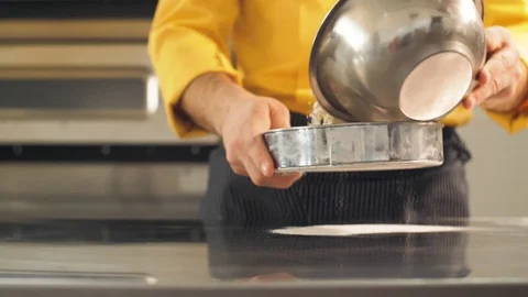 Cook sieved the flour through a sieve for baking Stock Footage 127887288