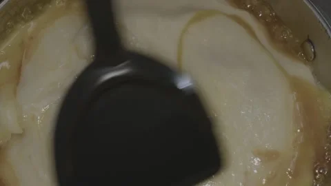 Cook skillfully uses miniature cookware in a tiny kitchen stirring a delicious Video stock 286903326