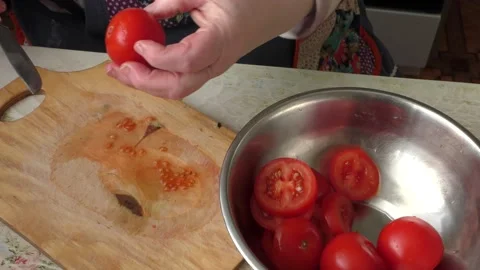 Cook slices tomatoes with a knife Stock Footage 148947746