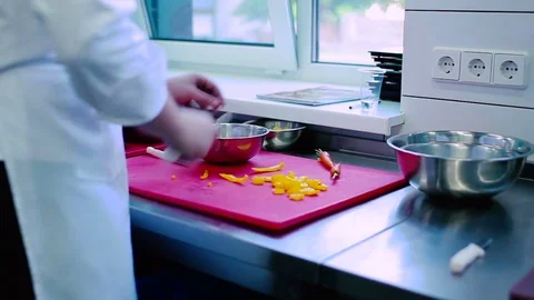 The cook slicing the pepper on the board Stock Footage 77709412