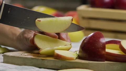 Cook slicing up red apple - closeup, slow motion Stock Footage 341271464
