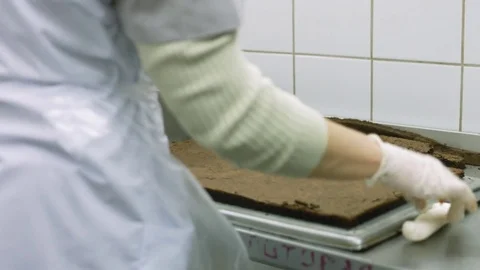 Cook smears jam over the large biscuit cake in the production Stock Footage