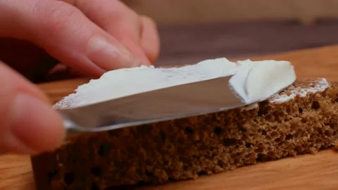 The cook spreads the cheese on the brown bread. Making sandwiches Healthy eating Stock Footage 150116671