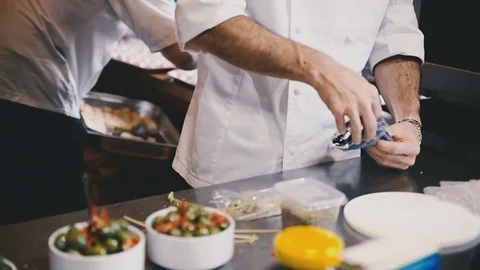 Cook spreads the spoons into bowls Stock Footage 81543373