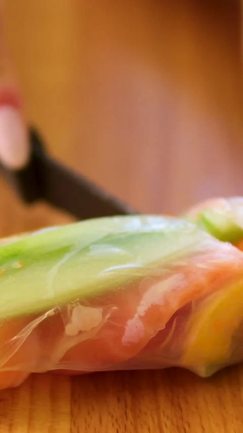 Cook spring rolls with carrots red fish pepper and cucumber vegetables seafood Stock Footage 302730553