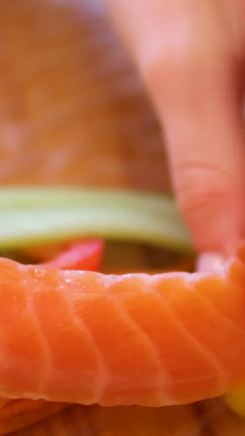 Cook spring rolls with carrots red fish pepper and cucumber vegetables seafood Stock Footage 302731154