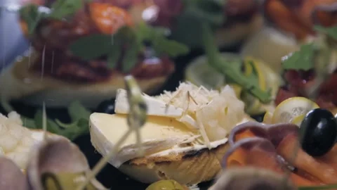 Cook sprinkled with cheese as dressing on cooked dish with ham slices finishing Stock Footage 146768379