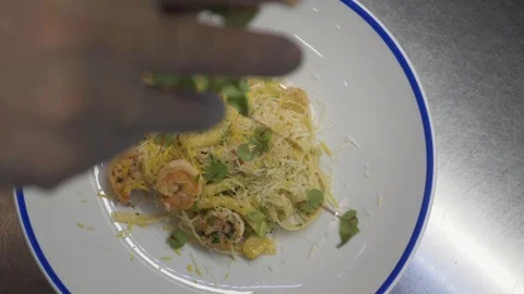 Cook sprinkles the finished pasta with micro greens. Hot dish. Service Video stock 88967098