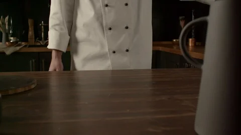 Cook sprinkles flour on a table in the kitchen, cooking pasta in slow motion 動画素材 120178250