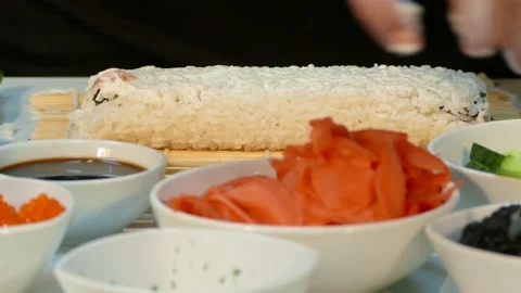 The cook sprinkles sushi roll with black caviar. Stock Footage 88488965