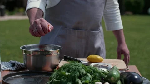 Cook squeezes lemon into a saucepan Video stock 228616487