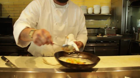 Cook station ladeling into pan Stock Footage 35409932