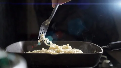 Cook stirs the noodles, Fry the Chinese noodles in the pan. slow motion. Stock Footage