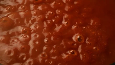Cook stirs tomato paste in pan Stock Footage 119715067