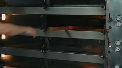 The cook takes bread from the stove Stock Footage 92581163