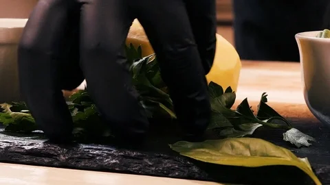 The cook takes the dill from the table and transfers it to the cutting board 動画素材 126489278