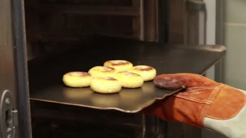 The cook takes out a baking tray from the oven, a large oven Stock Footage 166644818