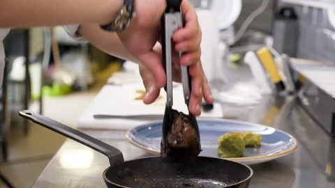 Cook taking a grilled beef steak Stock Footage 95903975