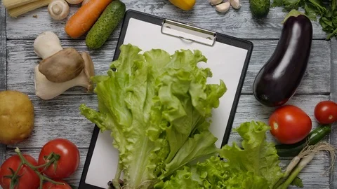 Cook taking lettuce from table with clipboard Stock Footage 119686500