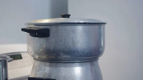 A cook is taking off the upper part of the couscous pot Stock Footage 129993449