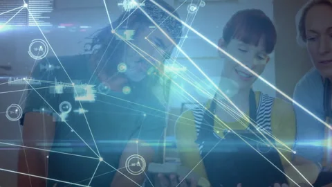 Cook tapping tablet and initiating kitchen AR data overlay while coworkers Stock Footage 309683520