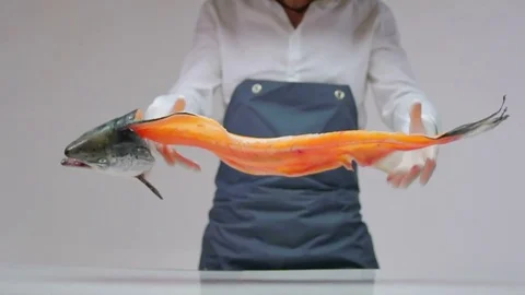The cook throws a large fish with a brushed torso on the table. Stock Footage 77721371