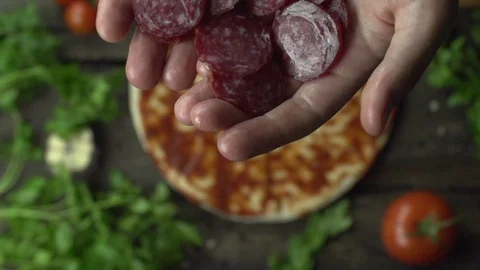 Cook throws pepperoni on pizza slow motion Video stock 96858740