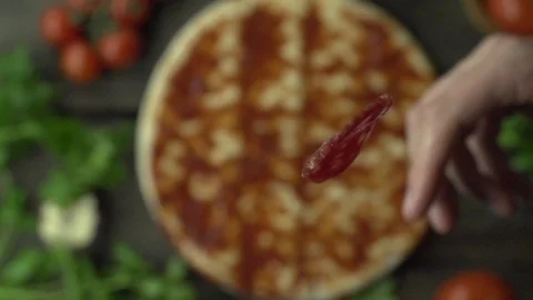 Cook throws pepperoni on pizza slow motion 動画素材 96858854