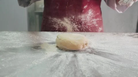 Cook throws piece of dough on an iron table Stock Footage 155203068
