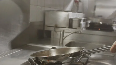 Cook throws vegetables in pan. Slow motion video Stock Footage 124686634