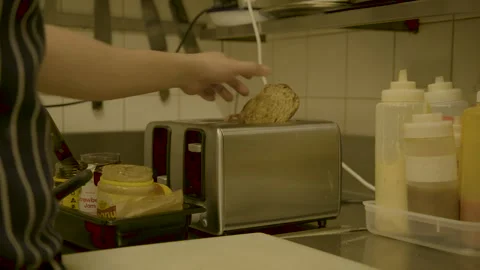 Cook Toasting and Preparing Bread in Cafe Kitchen, Sydney, Australia, March 2014 Stock Footage 345493151