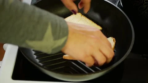 The cook is toasting bread in a frying pan. Stock Footage 161223440