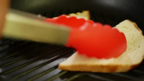 The cook is toasting bread in a frying pan. Stock Footage 161223945