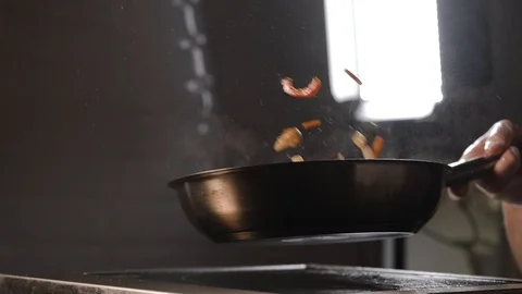 The cook tosses a wok in the pan Stock Footage 124275504