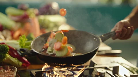 Cook tossing multicolored vegetables Stock Footage 311835272