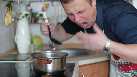 Cook tries the dish during cooking, he is disappointed Stock Footage 86574372