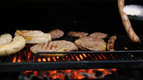 Cook turns the meat on the grill Stock Footage 107886369