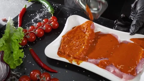 The cook turns over pieces of thin fillet marinated in sauce. Stock Footage 256126156