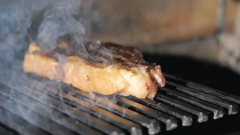The cook turns the steak on the grill Stock Footage 221119559