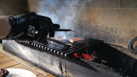 The cook turns the steak on the grill Stock Footage 221119581