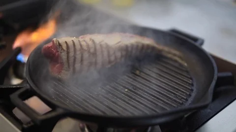 A Cook Turns Up A Steak Of Meat On A Grill Stock Footage 83587635