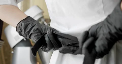 Cook tying a kitchen apron in the kitchen. Close-up Stock Footage 140288258